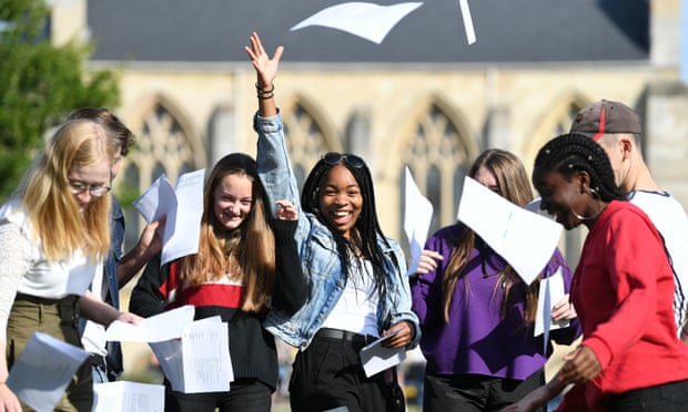 Somto Elumogo (centre) celebrates her GCSE results with friends at Norwich School.