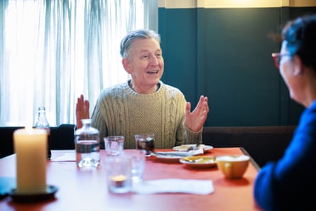 A man and woman facing each other across a restaurant table