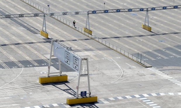 A man walks through the normally bustling but now empty passenger lanes at the busy Port of Dover in Kent, UK. 