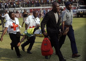 A casualty is rushed off the field after a stampede at the Rufaro stadium in Harare on Thursday.