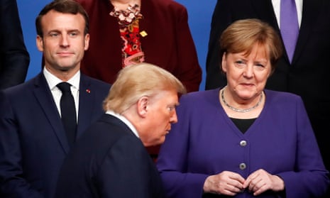 Emmanuel Macron and Angela Merkel watch Donald Trump during a ‘family photo’ at the Nato summit in Watford, England, in December 2019.