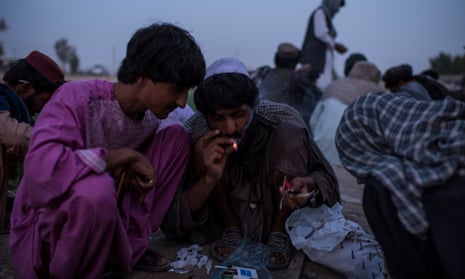 Opium addicts gather to smoke by a wall in a public park in Lashkar Gah, the capital of Helmand province, where half of Afghanistan’s opium is produced.