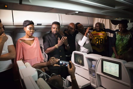 Kunle Afolayan (centre) with actors and passengers in flight during the premiere of his film The CEO.
