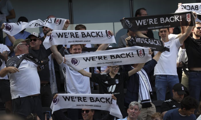 Fulham fans show off their scarves.