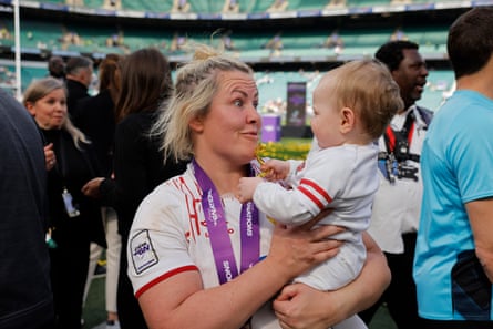 Marlie Packer with son, Oliver, after completing the grand slam against France in 2023.