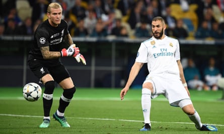 Real Madrid’s French forward Karim Benzema  scores a goal past Liverpool’s German goalkeeper Loris Karius