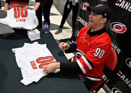 Dave Ayres signs autographs for fans during the game between the Dallas Stars and Carolina Hurricanes in February.