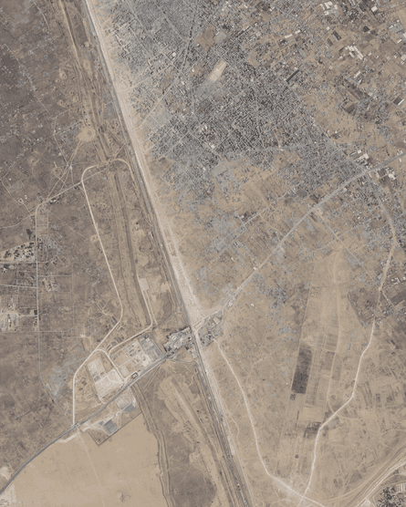 The Rafah crossing in late June 2024, with a new road built by the Israeli military below it. Destruction of Rafah city is visible above.