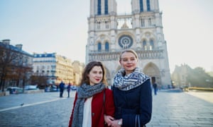 Two young girls near Notre-Dame in ParisTwo young girls walking together in Paris near Notre-Dame cathedral.