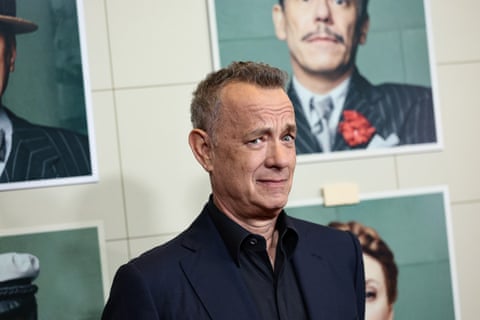 Man in black suit without tie raises eyebrow at cameras.