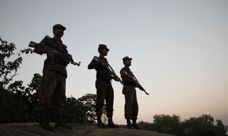 Bangladeshi border guards on the bank of the Naf river watch for the illegal entry of Myanmar Rohingya.