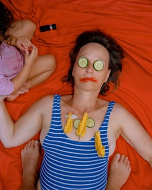A woman gets spa treatment at the hands of a small child