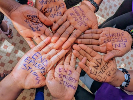 The message 'end epilepsy stigma' is seen written on seven hands joined together