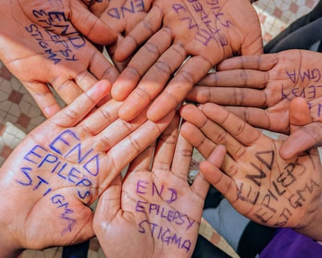 The message 'end epilepsy stigma' is seen written on seven hands joined together