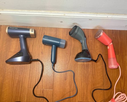 The best clothes steamers in a row on a wooden floor.