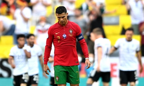 Cristiano Ronaldo (C) of Portugal reacts as German players celebrate their 1-1 equalizer.