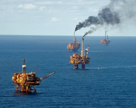 five oil rigs in the North Sea, blowing smoke from the top