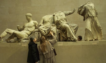 Experts examine statues from the Parthenon frieze at the British Museum.