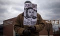 A man, who was demanding the criminal indictment of a white police officer who shot dead an unarmed black teenager in August, holds an image of Michael Brown outside the Ferguson Police Station in Missouri November 24, 2014. A St. Louis Country prosecutor is expected to make an announcement later on Monday on the grand jury that has been reviewing whether to charge a Ferguson, Missouri, police officer in the August shooting of an unarmed black teen, CNN reported, citing an unnamed law enforcement source. The grand jury has been meeting for more than three months, considering the Aug. 9 incident in which white police officer Darren Wilson shot and killed 18-year-old Michael Brown.  REUTERS/Adrees Latif  (UNITED STATES - Tags: CRIME LAW CIVIL UNREST POLITICS)