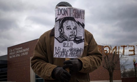 A protester holds an image of Michael Brown in Ferguson. 