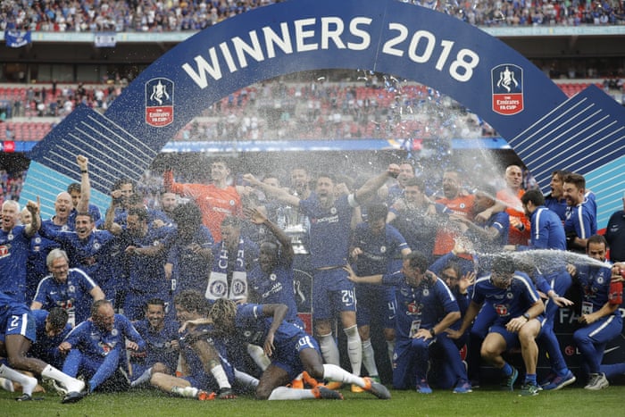 The Chelsea players celebrate on the pitch.