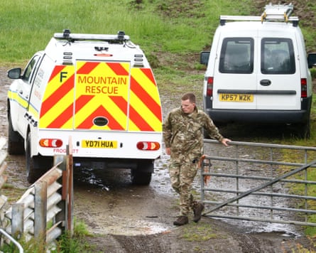 Man opening a gate for a Mountain Rescue vehicle