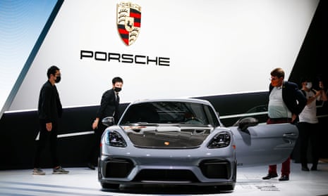 Attendees look at the 2022 Porsche 718 Cayman GT4 RS during the 2021 LA Auto Show
