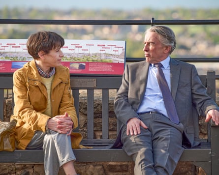 Sally Hawkins as Philippa Langley and Steve Coogan as John Langley sitting on a bench in The Lost King.