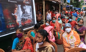 Indian sex workers wearing face masks as a precaution against coronavirus gather to worship Hindu goddess Durga at a worship place set up at Sonagachhi, a red light district, in Kolkata, India.