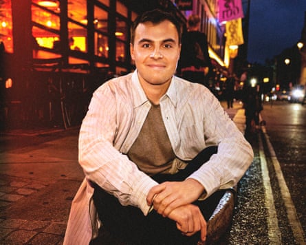 Meredith sitting on the pavement on a street in Soho, London