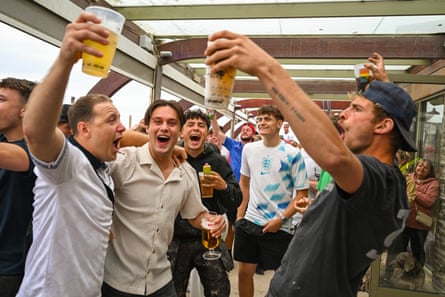 English fans toast a Harry Kane goal with beer