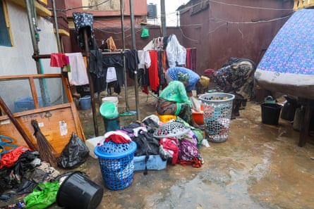 Cleaners wash Daniel Ebiesua’s salvaged clothes and household items in the courtyard of his Lagos home after the flooding.