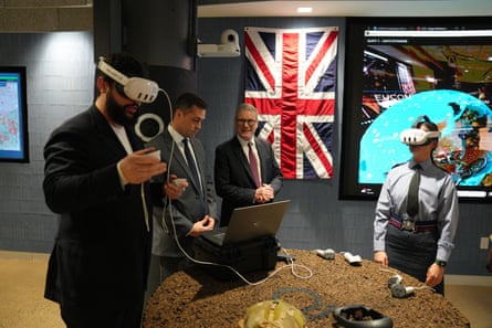 Keir Starmer stands next to military types who are using Palantir headsets that cover their eyes
