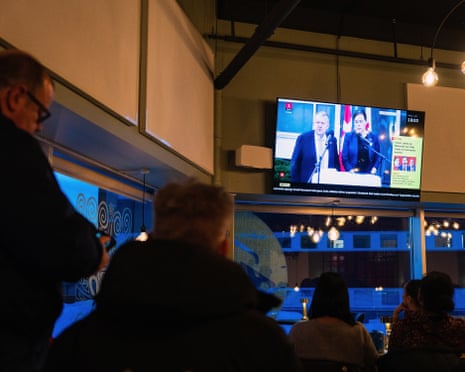People watch a press conference of Greenland’s foreign minister Vivian Motzfeldt and Denmark’s foreign minister Lars Loekke Rasmussen on TV in a restaurant in Nuuk, Greenland.