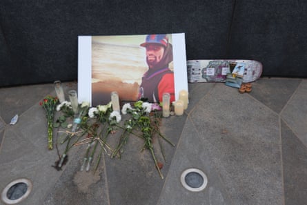 flowers next to portrait of nichols and skateboard that says ‘skate in heaven’