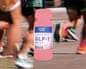 Marathon runners and a GLP-1 bottle image in a picture.