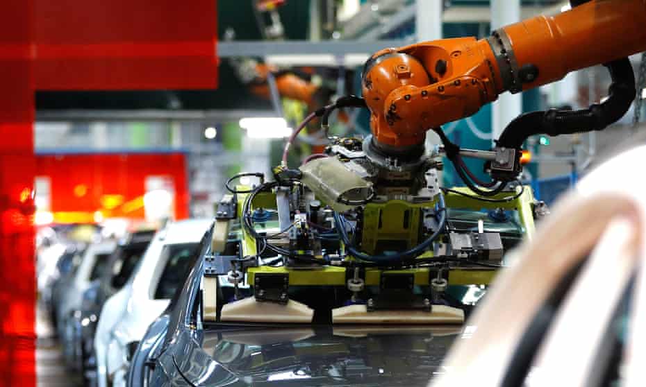 A robot adjusts a windscreen on the production line at the Daimler factory in Rastatt.
