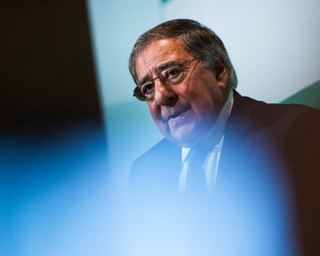 An older man in a suit speaks