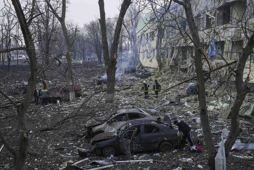 Ukrainian emergency employees work at a maternity hospital damaged by shelling in Mariupol