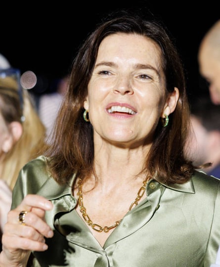 Emma Tucker in green satin blouse and gold necklace
