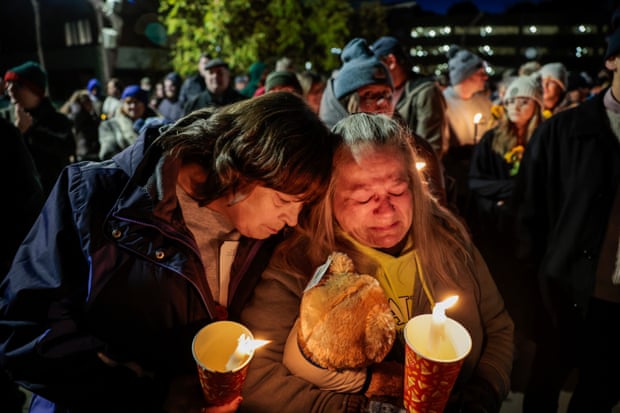People hold a vigil on 2 November for the victims of the mass shooting in Lewiston, Maine.