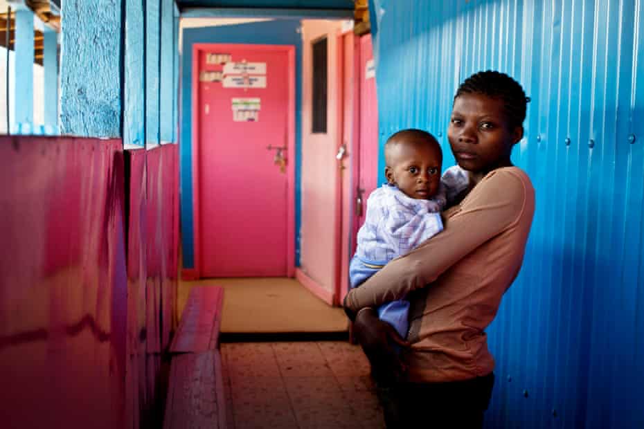 Celestine, 19, holds her son Raven at a health clinic in Kibera.
