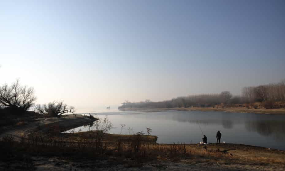 Two men fish on the banks of the Danube river near the Bulgarian town of Vidin.