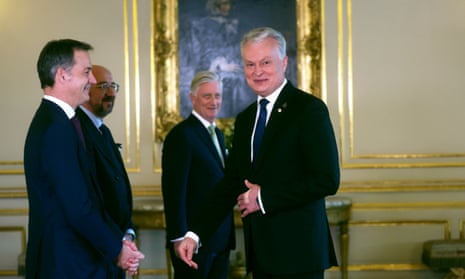 Lithuania's President Gitanas Nauseda, right, is greeted by, from left, Belgium's Prime Minister Alexander De Croo, European Council President Charles Michel and Belgium's King Philippe during a reception at the Royal Palace.