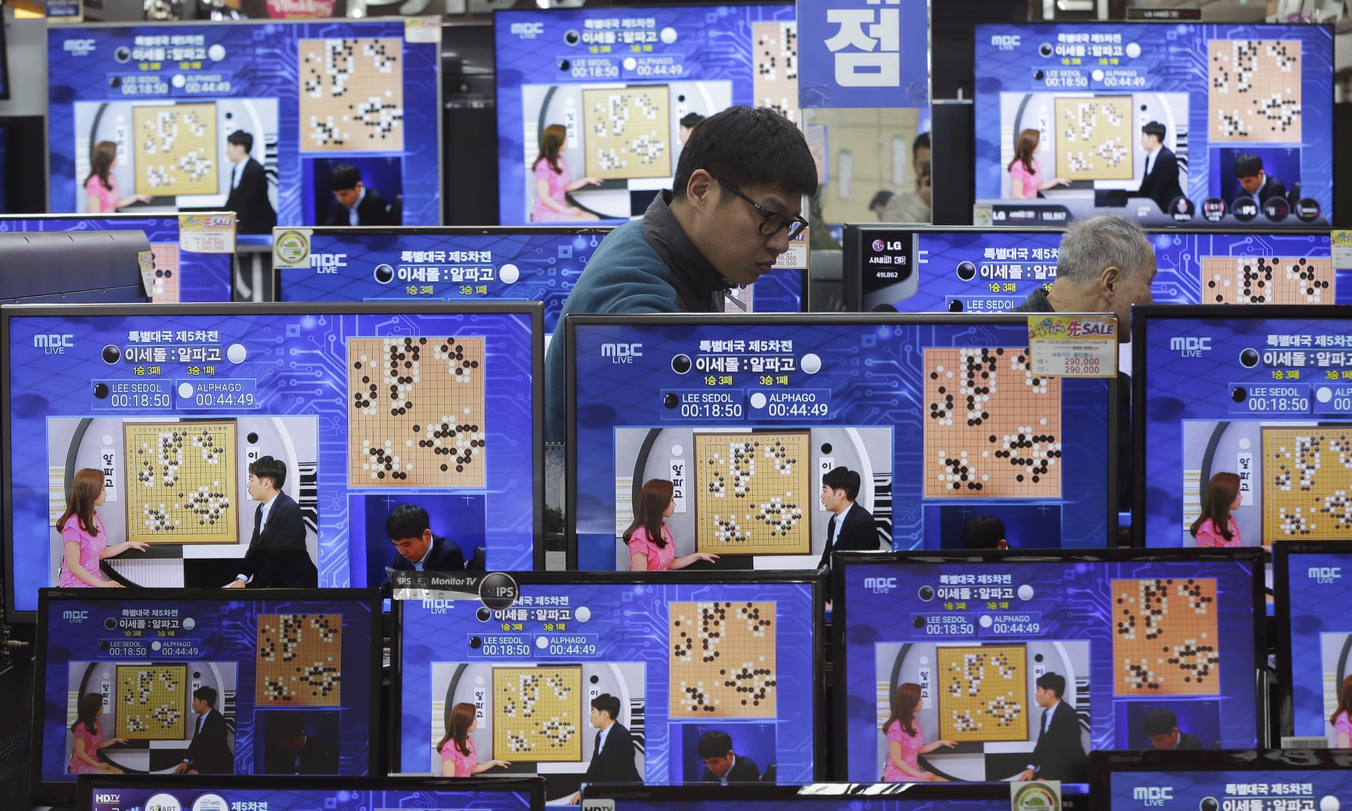 TV screens show the live broadcast of the Google DeepMind Challenge Match between Google’s artificial intelligence program, AlphaGo, and South Korean professional Go player Lee Sedol, at the Yongsan Electronic store in Seoul, South Korea.
