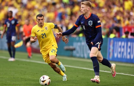 Jerdy Schouten considers his options while Romania’s Nicolae Stanciu tries to cover him
