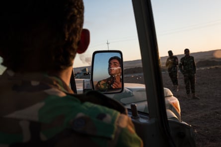 A Peshmerga shaves on the side of the Hawler - Kirkuk road after his unit fled Kirkuk.