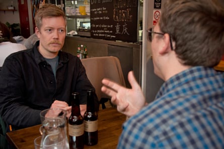 Stuart listening as Jo gesticulates at the restaurant table