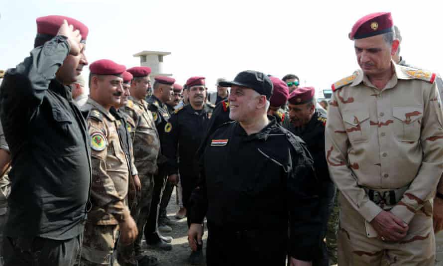 The Iraqi prime minister, Haider al-Abadi, centre, greeting army officers upon his arrival in Mosul.