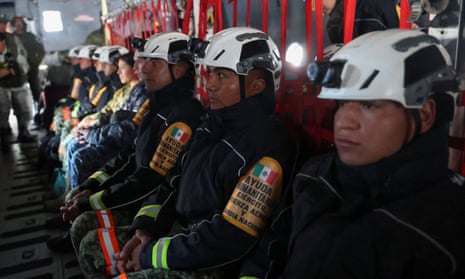 A Mexican military and fire aid team sit on a plane bound for California to help fight wildfires, at Felipe Angeles International Airport, in Zumpango, Mexico, January 11, 2025. REUTERS/Luis Cortes